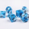 Collection of seven acrylic dice with swirled white and turquoise blue colouring and black numbers