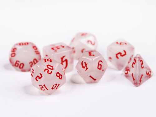 Collection of seven acrylic dice with fine glittery off-white colouring and red numbers