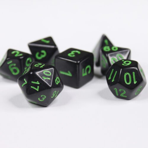 Collection of seven acrylic dice with plain black colouring and green numbers