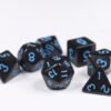 Collection of seven acrylic dice with plain black colouring and blue numbers