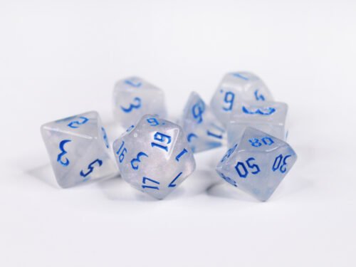 Collection of seven acrylic dice with fine glittery off-white colouring and blue numbers