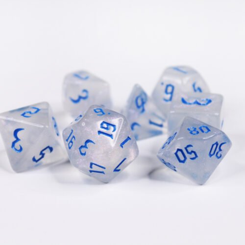 Collection of seven acrylic dice with fine glittery off-white colouring and blue numbers