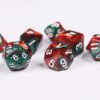 Collection of seven acrylic dice with swirled pearly red and green colouring and white numbers