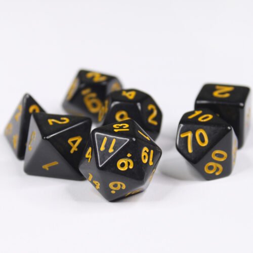 Collection of seven acrylic dice with plain black colouring and yellow numbers