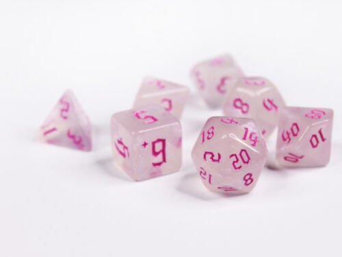 Collection of seven acrylic dice with fine glittery off-white colouring and pink numbers