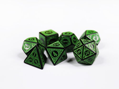 Collection of seven black dice with embossed swirling patterns and green coloured motif and numbering