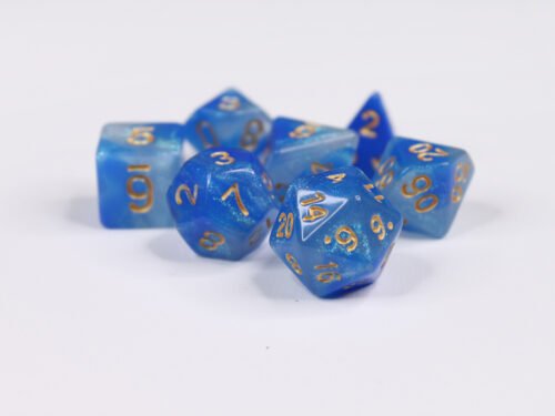 Collection of seven acrylic dice with fine glittery swirled white and blue colouring and gold numbers