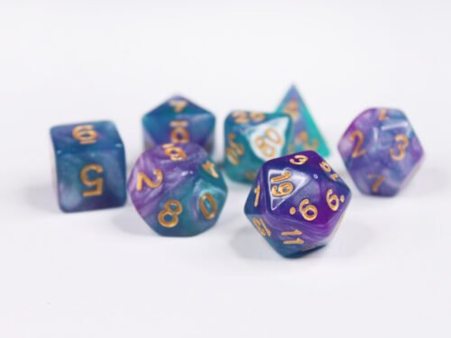 Collection of seven acrylic dice with swirled fine glittery purple and turquoise colouring and gold numbers