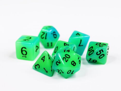 Collection of seven glow-in-the-dark acrylic dice with swirled green and blue colouring and black numbers