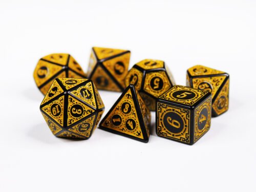 Collection of seven black dice with embossed swirling patterns and yellow coloured motif and numbering