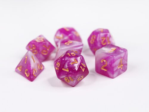 Collection of seven acrylic dice with swirled fine glittery pink and white colouring and gold numbers