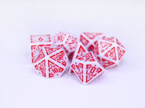 Collection of seven white dice with embossed moon and star patterns and red coloured motif and numbering