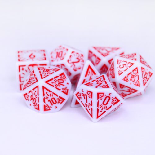 Collection of seven white dice with embossed moon and star patterns and red coloured motif and numbering