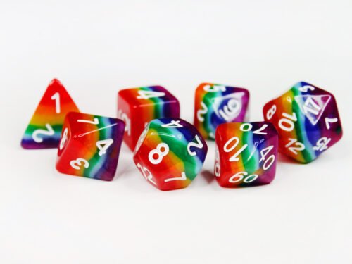 Collection of seven acrylic dice with rows of colour like a rainbow and white numbers