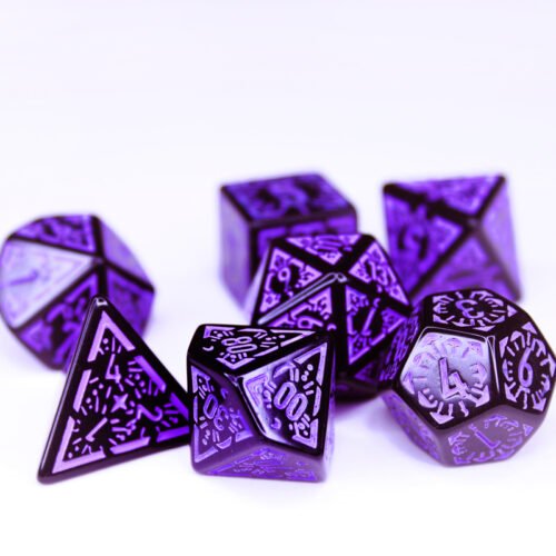 Collection of seven black dice with embossed moon and star patterns and purple coloured motif and numbering