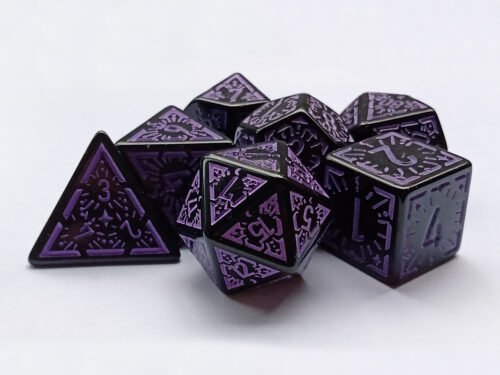 Collection of seven black dice with embossed moon and star patterns and purple coloured motif and numbering