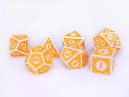 Collection of seven white dice with embossed swirling patterns and yellow coloured motif and numbering