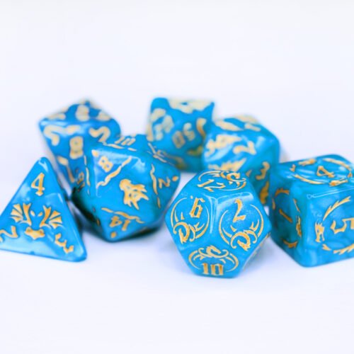 Collection of seven turquoise dice with embossed dragon patterns and gold coloured motif and numbering