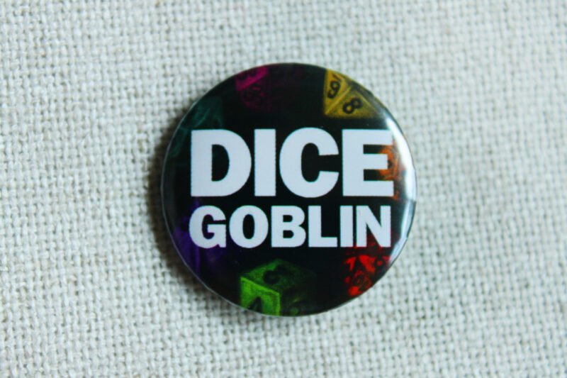 A button badge showing a green D6, A red D20 a yellow D8, an orange D12, a pink D10, a turquoise D D100, a purple D4 and the text Dice Goblin