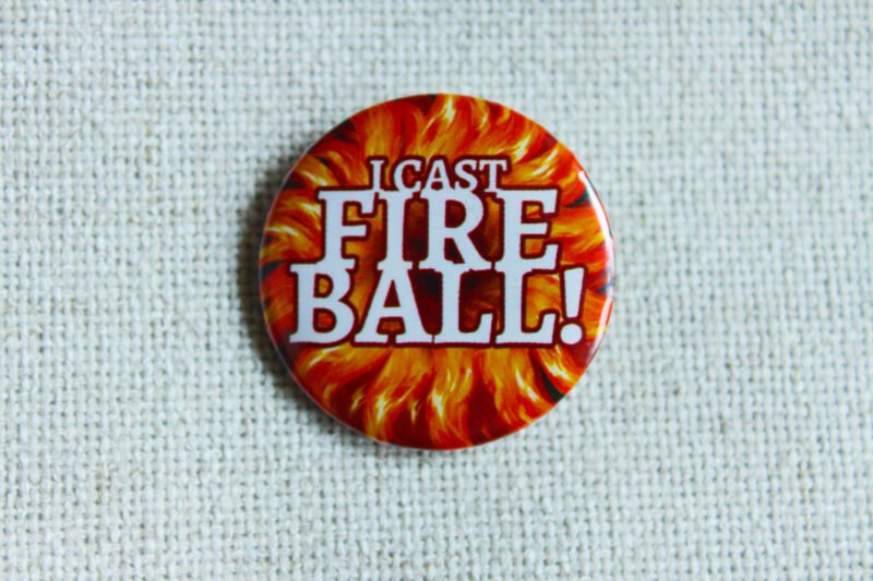 A button badge showing a firey central burst with the text I cast Fire Ball! across it in white