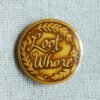 A gold coloured button badge illustrated to look like a coin with the text Loot Whore on it and decorative leaves.