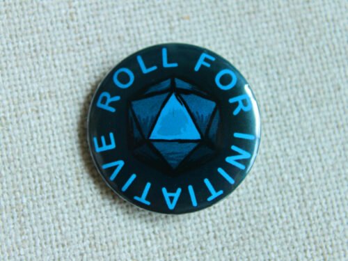 A dark blue button badge with turquoise coloured text reading Roll for Initiative and a centrally an illustrated D20