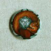 A button badge showing a European red squirrel curled around a grey coloured D20 Die