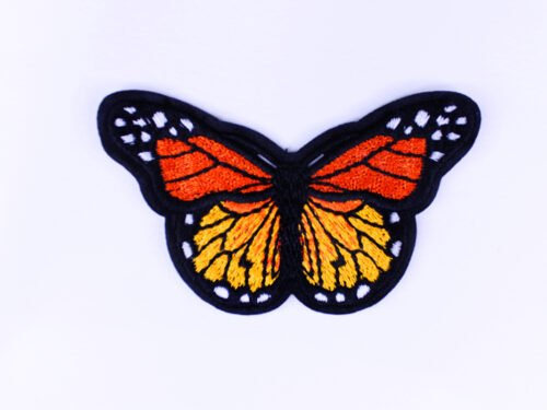 An embroidered patch of a orange black and white monarch butterfly with its wings spread wide.