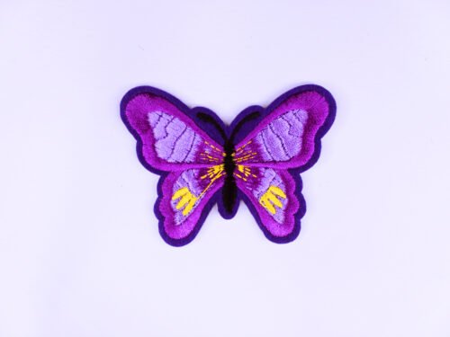 An embroidered patch of a purple butterfly with yellow and light purple markings.