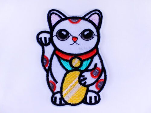 An embroidered patch of a Maneki Neko cat holding a gold disk and waving.