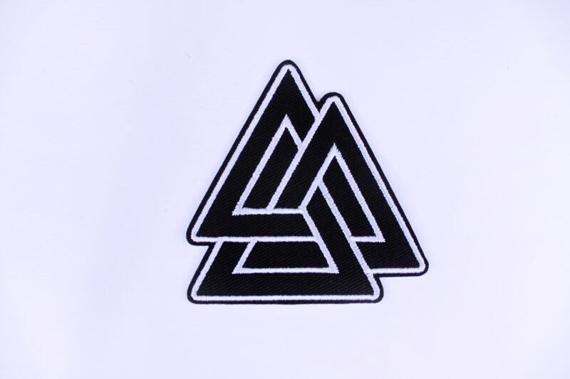 An embroidered patch of the Norse symbol Valknut in the colours black and white