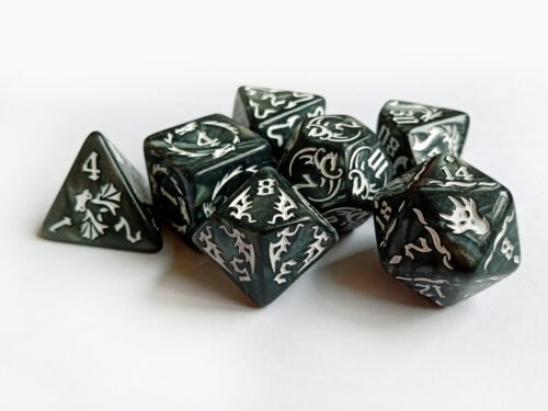 Collection of seven dark grey dice with embossed dragon patterns and white coloured motif and numbering.