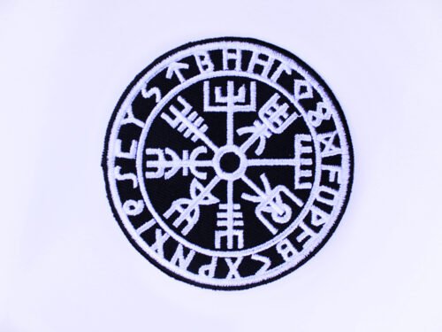 A circular embroidered patch of a the Norse compass Vegvisir encircled by viking runes in black and white